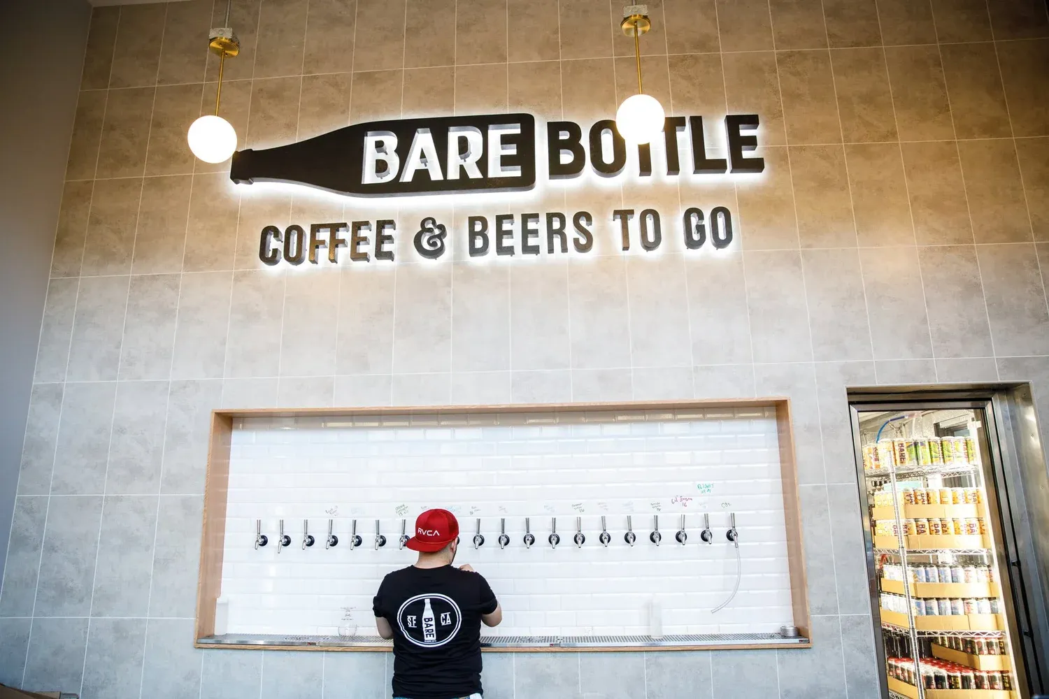 A bartender pouring a beer at the Barebottle Santa Clara taproom.