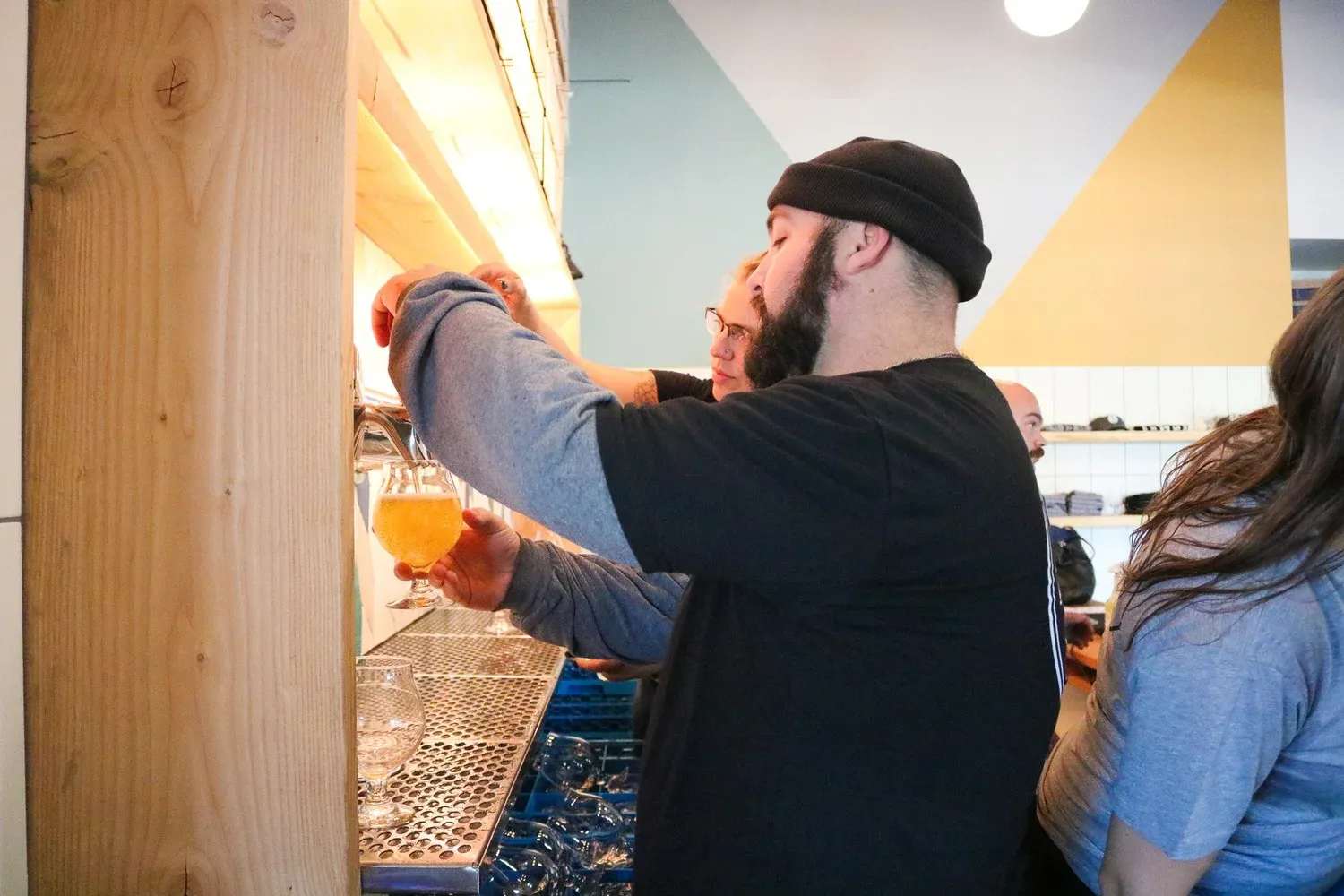 A bartender pouring a fresh beer at the Barebottle Walnut Creek taproom.