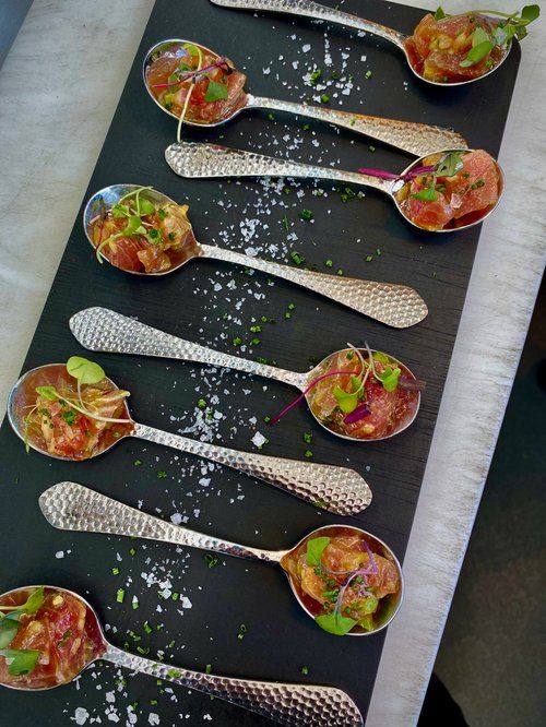 Catering spread of Detroit-style pizzas at an event
